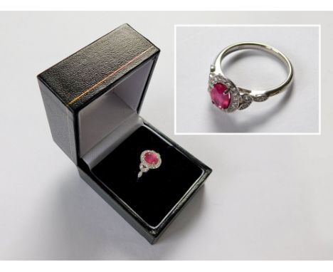 RIVER MOUNTS RING. An 18ct. white gold, River Mounts ruby & diamond cluster ring, the ruby of approx. 1.3ct. spread. Size L. 