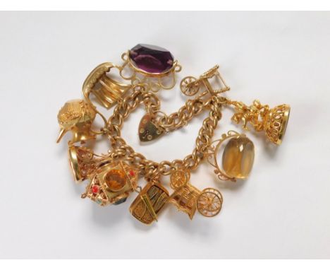 CHARM BRACELET. A 9ct. gold curb link charm bracelet with 9ct. gold padlock clasp. Hung with ten, mostly modern, 9ct. gold ch