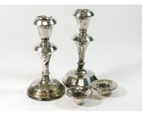 CANDLESTICKS ETC. A pair of Chester silver candlesticks, 1919. Height 14.5cm. (Worn at the base of each column). Also, two si