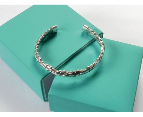 JAMES SUDDABY. A contemporary, hand made James Suddaby 999 fine silver 'Newlyn Rope' twist torque bangle. Applied naming & Bi