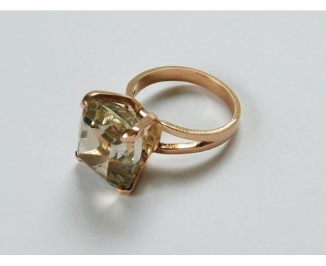 DRESS RING. A dress ring set a well faceted, large smoky quartz in unstamped yellow metal. Size of stone 14x14x7mm. Size Q/R.