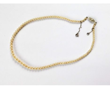 PEARLS. A single string of graduated cultured pearls on 9ct. white gold, pearl set clasp. Largest pearl approx. 5mm. Length a