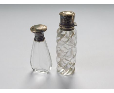 SCENT BOTTLES. A 1920s scent flask with silver screw top & glass stopper. Height 6cm. Also, a smelling salts bottle with deta