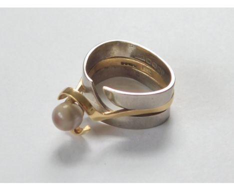 RAY SEMPLE RING. A bespoke, Ray Semple designed, 18ct. yellow & white gold interlocking ring, set a spherical agate stone. Al