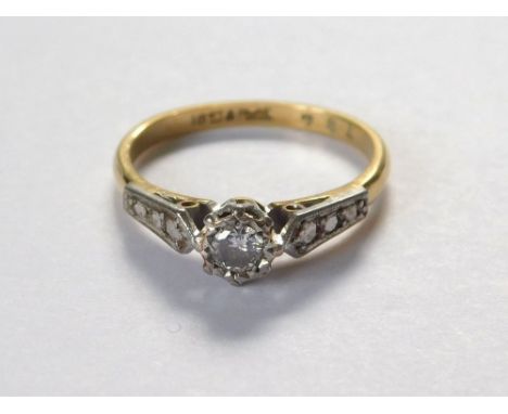 DIAMOND RING. An 18ct. gold & platinum solitaire diamond ring with platinum shoulders. Size L.  Please note that all items in