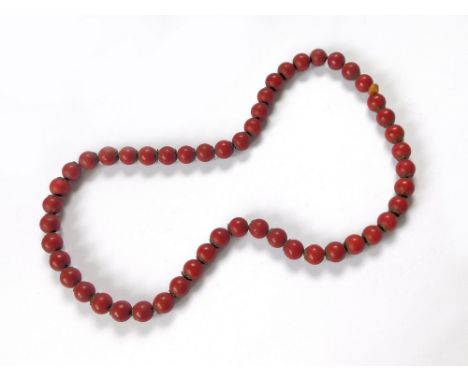 AFRICAN NECKLACE. An early 20th century red bead necklace, possibly seeds.  Please note that all items in this auction are pr