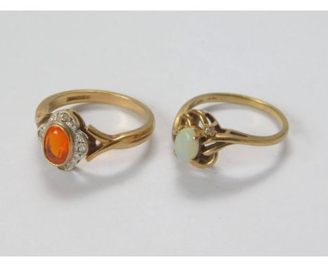 OPAL RINGS. An 9ct. gold ring set a fire opal in an illusion set, four-stone diamond border. Also, a 10k. opal & diamond dres