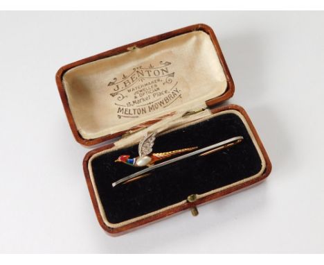 PHEASANT BROOCH. A 15ct. gold & platinum flying pheasant bar brooch, with blister pearl & enamelled body & diamond set wings.