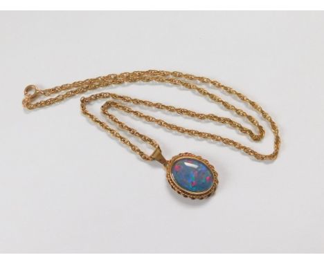 OPAL PENDANT. A 9ct. gold mounted opal pendant in closed back setting & hung on a 9ct. gold fancy link chain. Length of penda