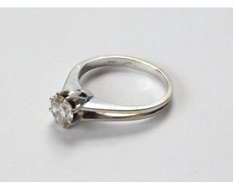 SOLITAIRE DIAMOND RING. An 18ct. white gold solitaire diamond ring with split shoulders, the diamond held in coronet setting.