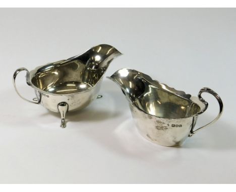 GRAVY BOATS. Two silver gravy boats; one standing on three swept feet, Sheffield 1937; the other with pierced handle, London 