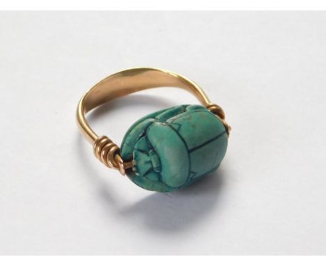 SCARAB RING. A turquoise glazed pottery scarab, set in a yellow metal (probably 18ct. gold) ring. Metal unmarked. Size L.  Pl