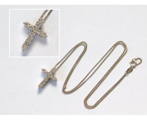 DIAMOND CROSS. A 14k. cross pendant set with 11 brilliant cut diamonds & hung on an 18ct. white gold fine chain. Length of cr