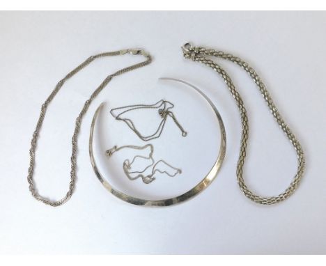 SILVER TORQUE ETC. A plain silver torque necklace, two other silver necklaces & two silver chains.  Please note that all item