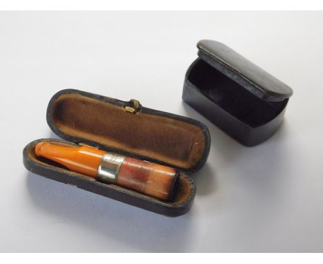SNUFF BOX ETC. A plain papier mache snuff box & a silver mounted cigar holder with amber mouthpiece. Sheffield 1906. In fitte