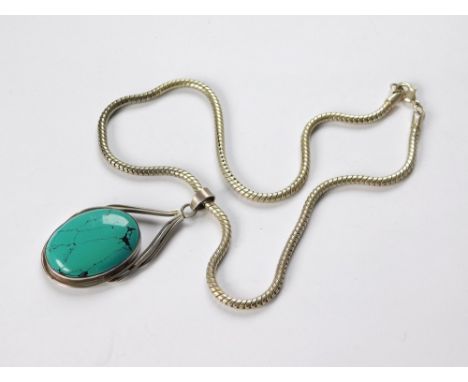 SILVER PENDANT & CHAIN. A large silver pendant set with a faux turquoise stone & hung on a substantial silver snake chain. Le