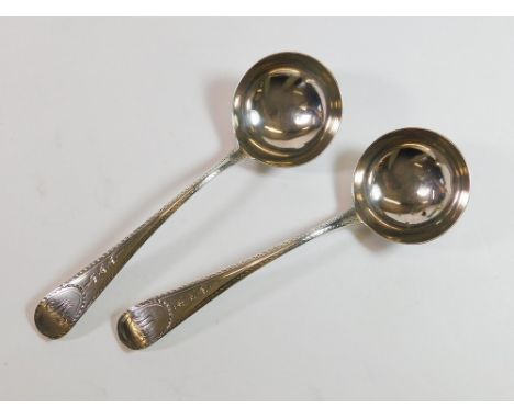 SAUCE LADLES. A pair of George III bright cut sauce ladles, each monogrammed. Maker's mark for John Lambe, London 1784. Appro
