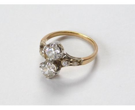 DIAMOND RING. An unstamped, yellow metal ring (probably 18ct. gold) set with two diamonds, each of approx. 0.75ct. spread, ea