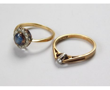 GOLD RINGS. A 9ct. gold solitaire diamond ring, size L/M & a sapphire & diamond cluster ring set in yellow metal. (Hallmarks 