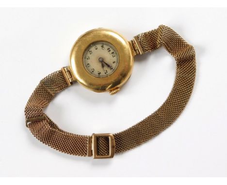 GOLD WATCH. A lady's 18ct. gold cased wristwatch with import marks for London 1911. Now fitted a 9ct. gold mesh strap.  All w