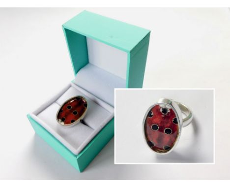 JAMES & SAMANTHA SUDDABY. A contemporary, hand made 'Ladybird' ring by James Suddaby, in 999 fine silver & with Japanese cloi