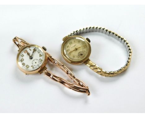 GOLD WATCHES. Two ladies 9ct. gold watches: an octagonal cased watch retailed by Thomas Russell & Son., on later gold-plated 