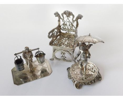 MINIATURES. An Edwardian small cherub figure holding a parasol. Import marks for London 1901. Also, a silver model of an armc