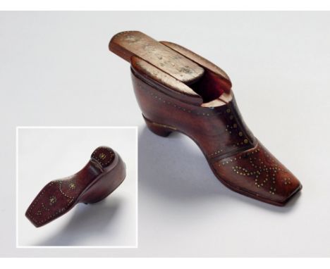 SNUFF SHOE. A 19th century wooden snuff shoe, the whole, including the sliding lid, decorated with a variety of small brass n