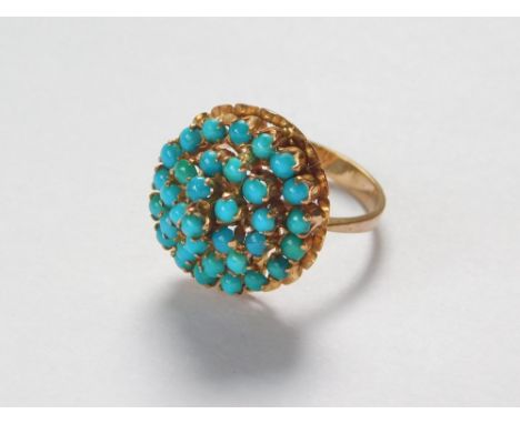 GOLD RING. An 18ct. gold turquoise set dress ring, set with concentric bands of turquoise. Size K.  Please note that all item