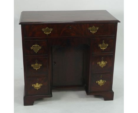 EARLY NINETEENTH CENTURY FIGURED MAHOGANY SMALL KNEEHOLE DESK, the moulded oblong top above a long, cockbeaded and flame cut 