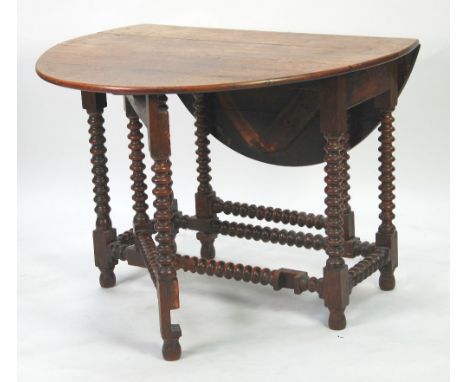 ANTIQUE OAK GATELEG DINING TABLE,  the oval top above a plain frieze and raised on bobbin turned supports, 30 1/2" (77.5cm) h