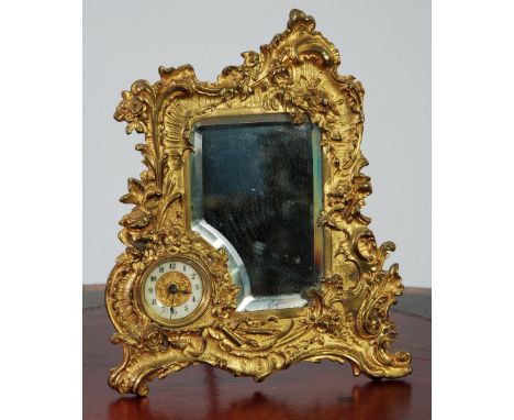 THE BRITISH UNITED CLOCK CO., LTD, EARLY TWENTIETH CENTURY BURNISHED AND GILT METAL COMBINATION DRESSING TABLE MIRROR and CLO