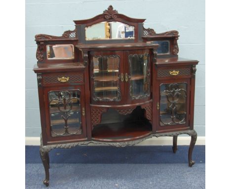 LATE VICTORIAN CARVED AND PIERCED DARK MAHOGANY DISPLAY/SIDE CABINET, the stooped top surmounted by a low back with three bev