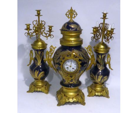 IMPRESSIVE TWENTIETH CENTURY GILT METAL AND BLUE PORCELAIN THREE PIECE CLOCK GARNITURE, the clock of two handled baluster for