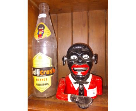 Robertsons collectables comprising a cast metal mechanical money box and a Gollicrush Orange juice bottle.Note:- These items 