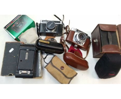 A box of old cameras to include Kodak, Brownie, Canon, etc. 