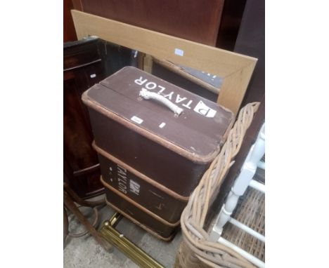 A vintage travel trunk together with a modern light oak framed mirror. 