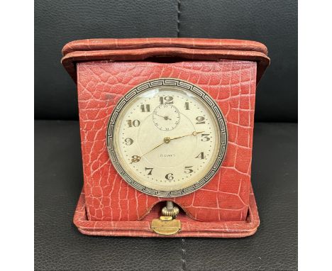 A red leather cased 8 day travelling clock 