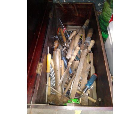 A wooden chest containing various woodworking tools, chisels, files, etc. 