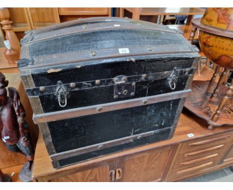 A vintage dome top travel trunk. 