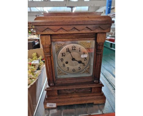 An oak cased bracket clock, with keys &amp; pendulum. 