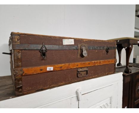 A vintage travel trunk with various old travel labels. 