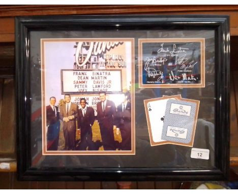 A Framed Rat Pack photo display with printed signatures and Sands Hotel playing cards. 