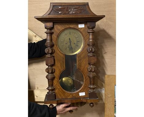 A large Vienna style mahogany cased wall clock with brass dial, key and pendulum, shipping unavailable 