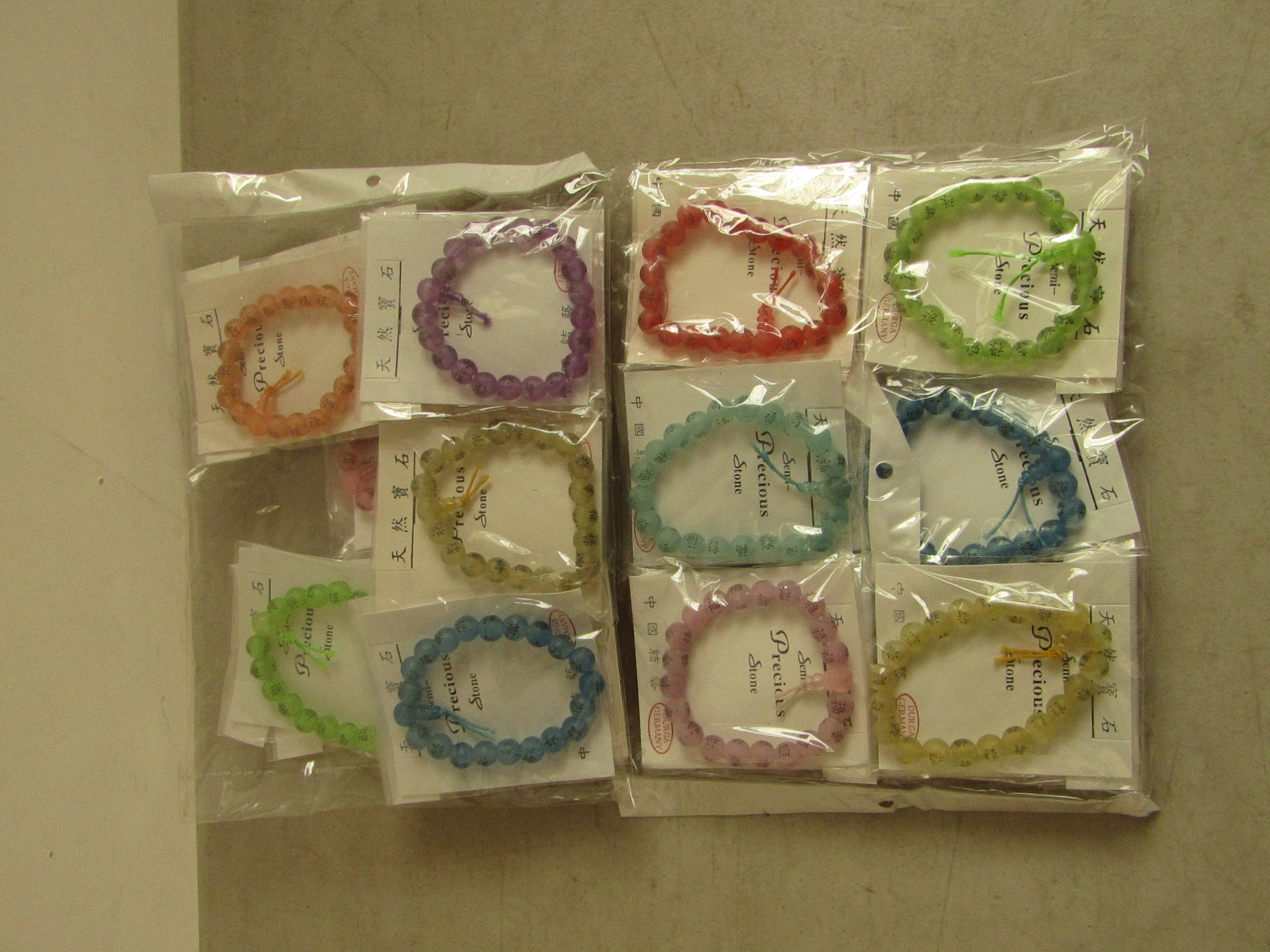 20x Packs of 12 various colour Budda Bead Bracelets. All new in packaging.