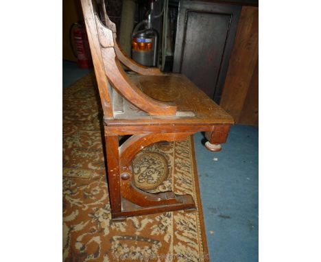 An Oak solid seated Side Chair of ecclesiastic flavour, part of one arm bracket lacking