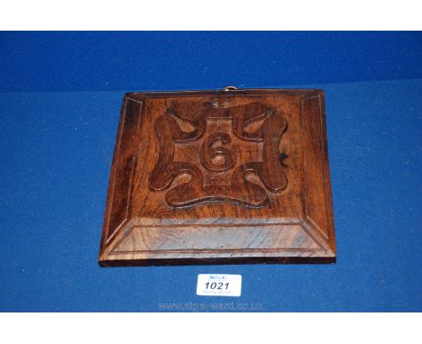 A carved Oak Plaque, engraved DW 1977 to rear with inset 1848 penny red stamp, and the front featuring pattern of post mark