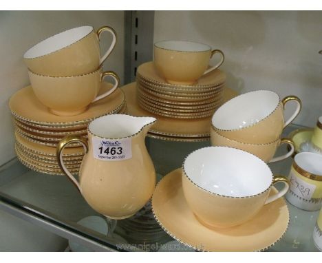 A Wedgwood part tea set in blush ground with gilt beaded edging to include; six cups, ten saucers, eleven tea plates, two cak