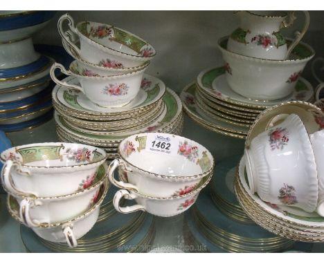 A Samuel Radford Ltd floral green &amp; gilt part tea set to include; twelve cups, twelve saucers, twelve tea plates, two cak