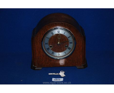 A 1930's Oak Smiths mantle Clock with Roman numerals, 7 1/2'' tall, with key.